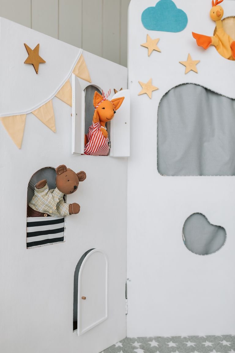 Colorful and playful puppet scene featuring handmade puppets in a decorated theater setting.